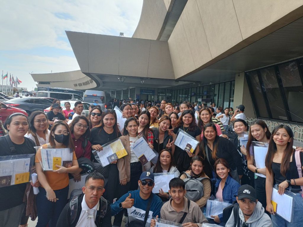 Filipino workers deployed by Mori International at the airport before departure
